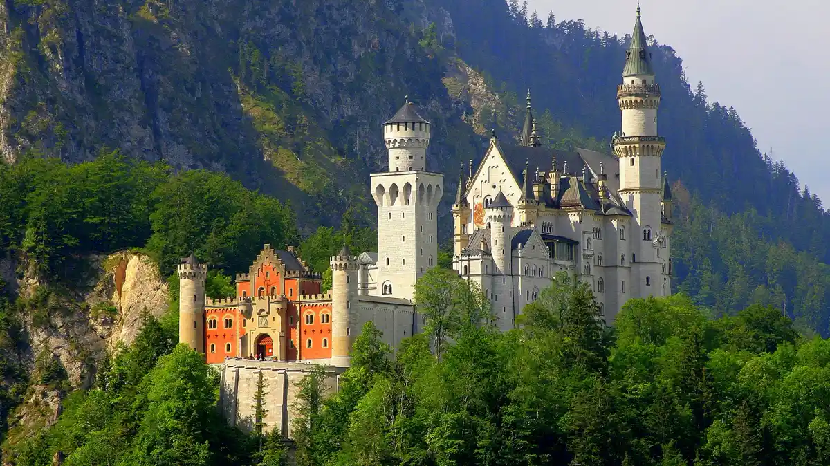 Neuschwanstein Castle above the forest in Bavaria